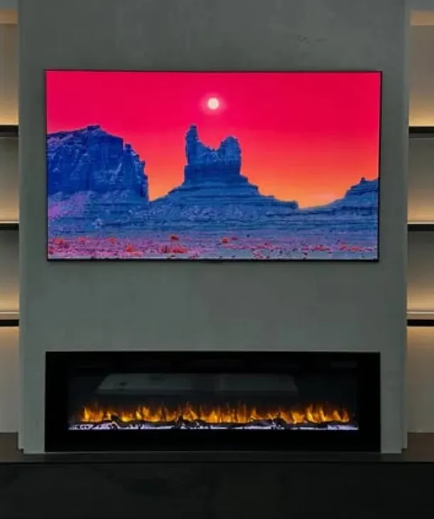Dark media wall with a linear fireplace and backlit niches