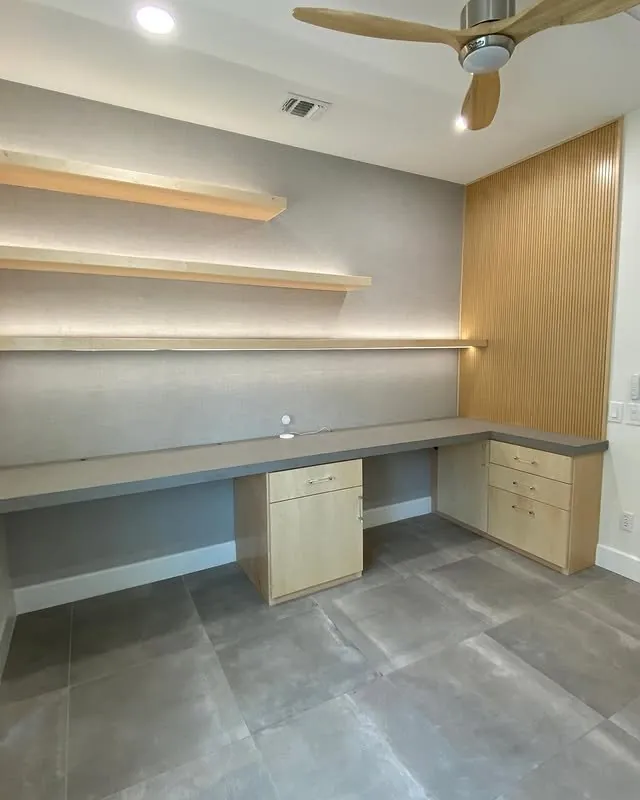 Maple office desk with floating shelves, LED uplighting and a textured wallpaper wall
