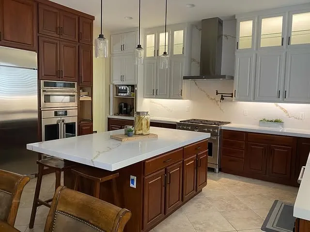 Henderson kitchen with a white quartz island, cherry base cabinets and white uppers to the ceiling