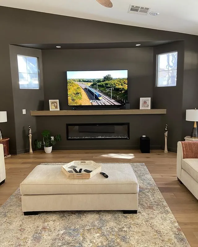 Living room media wall with a linear fireplace and a solid oak mantel shelf