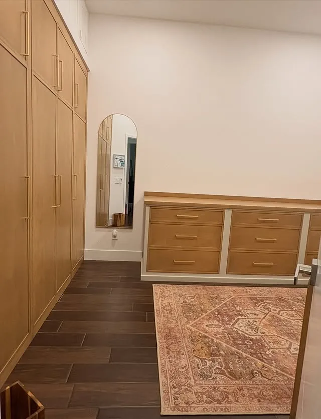 Stained cabinet run with a painted base on a patterned rug