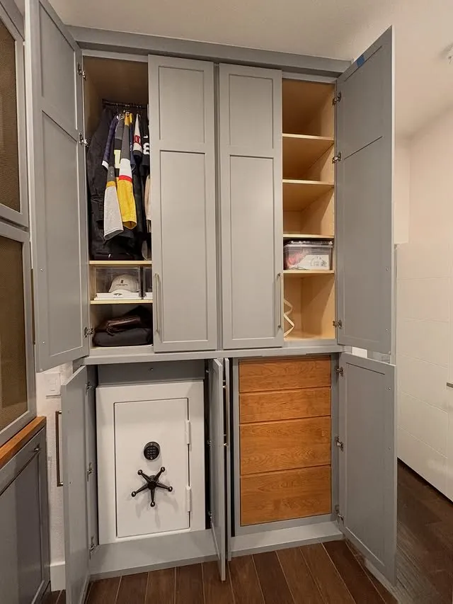 Pocket doors open on a safe and inset cherry drawers