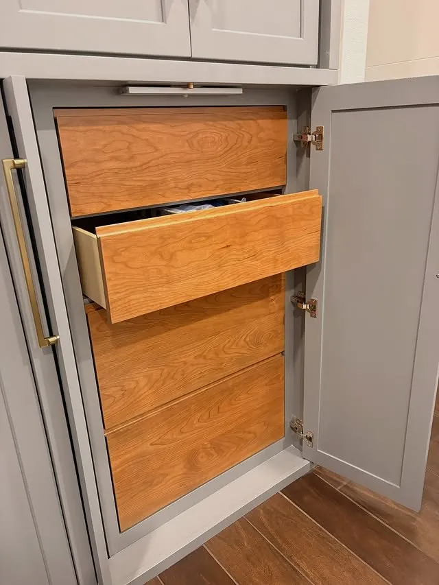 Inset cherry drawers pulled out behind the grey doors