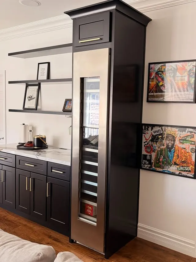 Black bar cabinetry with a tall wine column and floating shelves