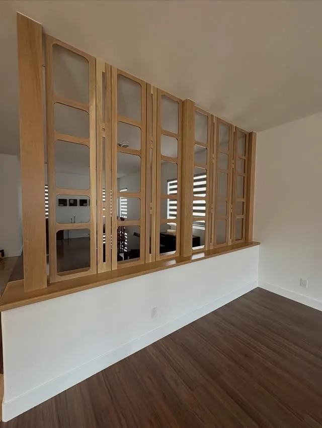 White oak panel divider with open squares between the living and dining rooms
