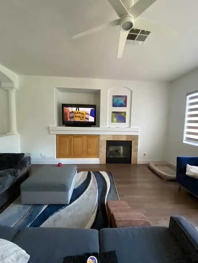 The living room before: a tiled fireplace with a small TV niche