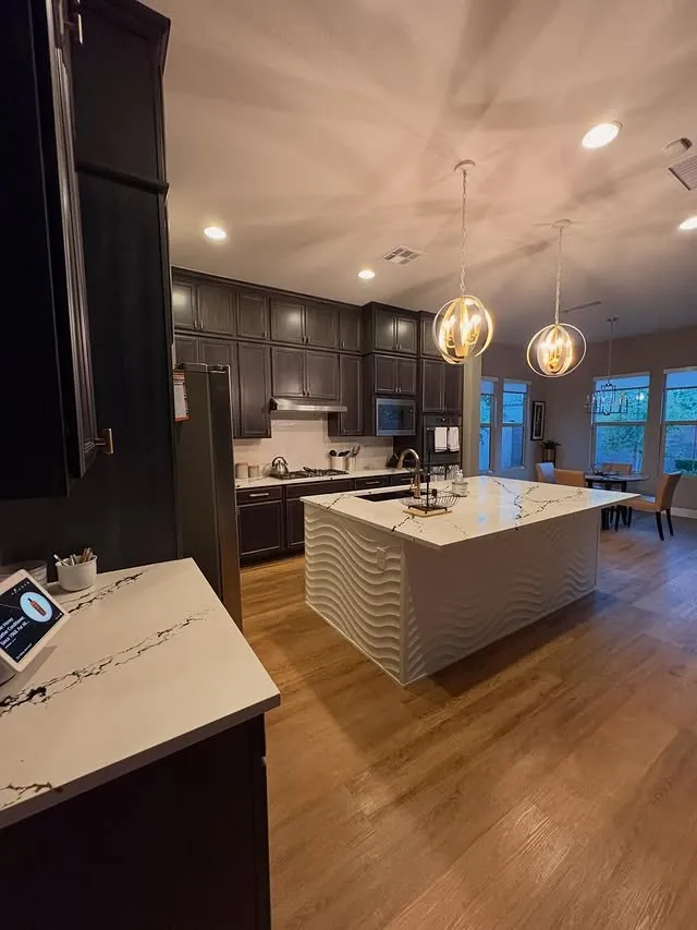 Island and dark cabinetry seen from the kitchen entry