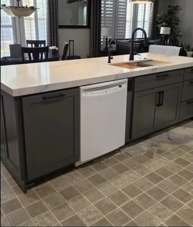 Grey kitchen island with a white counter and a dishwasher